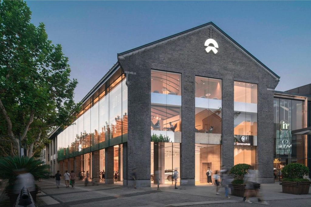 Imagery of the NIO House exterior as an application of the brand identity. Design by forpeople.