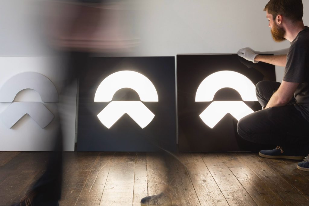 Photograph of Tim Blackburn, Associate Director, evaluating signage for the NIO Brand Identity. Film by forpeople.