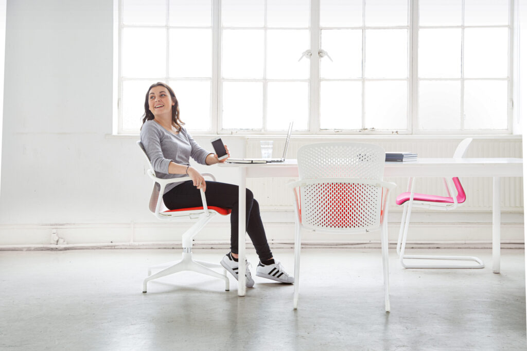 Photograph of a person sitting with a collection of Herman Miller Keyn Chairs, by forpeople.
