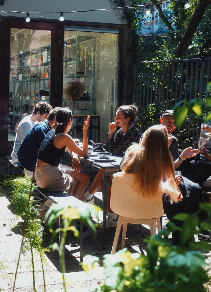Photograph of the Amsterdam team eating in their studio's garden.
